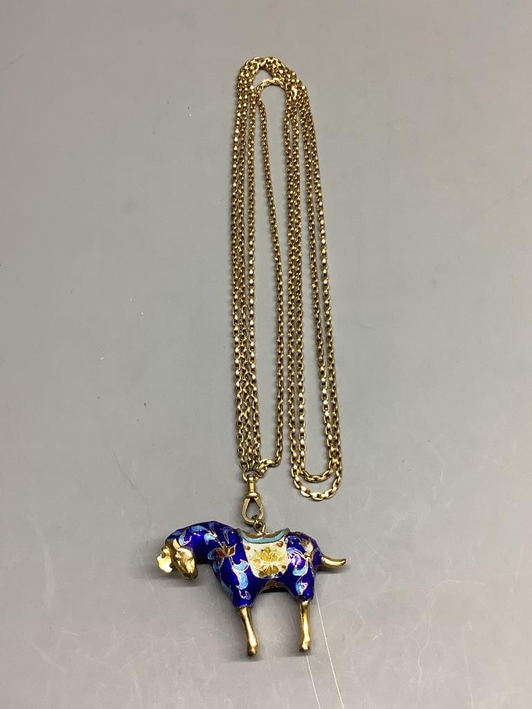 An enamelled gilt horse pendant on an unmarked yellow metal guard chain